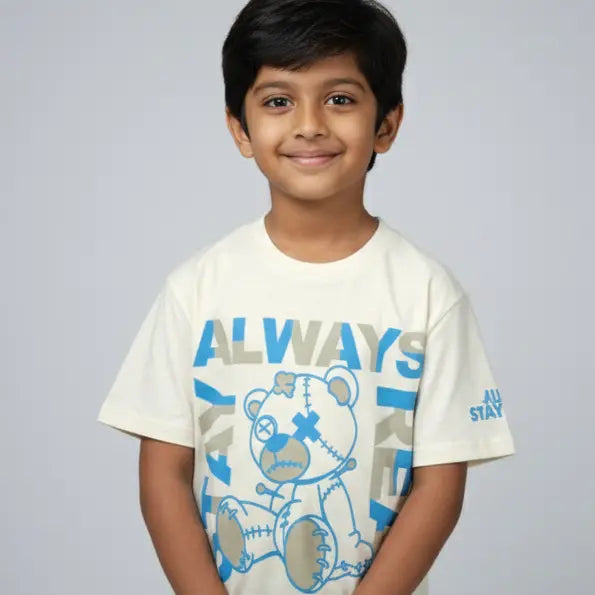 Child wearing a white t-shirt with a bear graphic and 'ALWAYS' text on a plain background